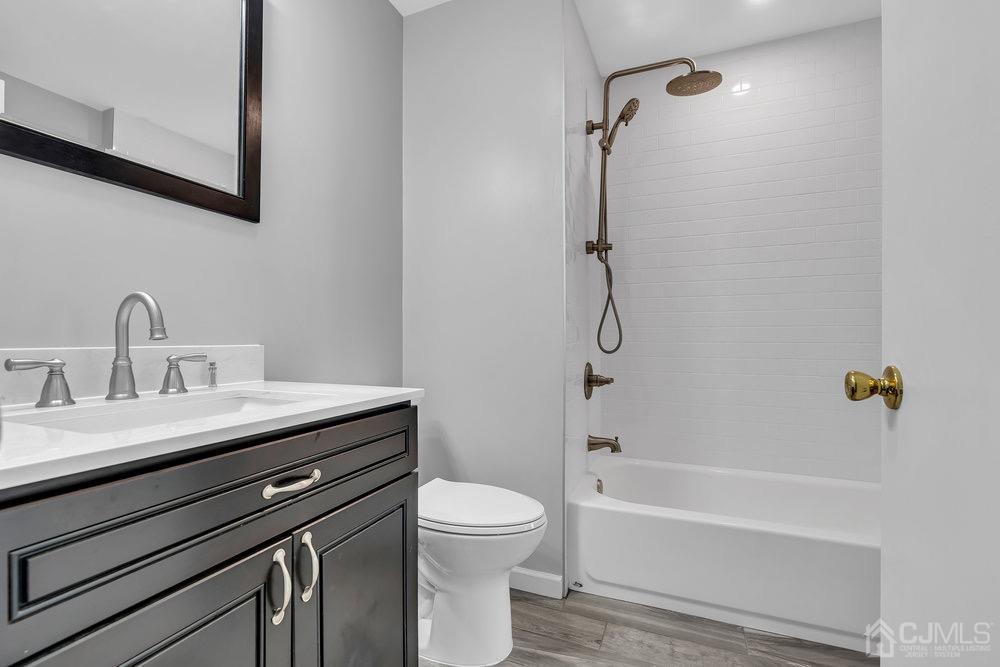1236 Edpas Road New Brunswick, NJ 08901 - Photo 13 of 26 a bathroom with a sink a toilet and shower