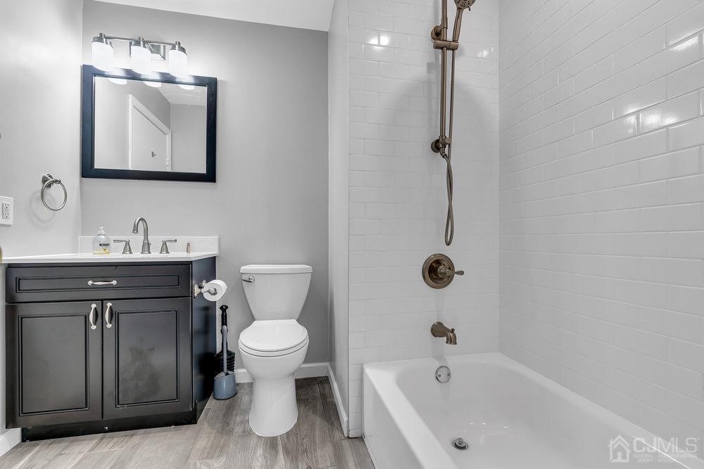 1236 Edpas Road New Brunswick, NJ 08901 - Photo 14 of 26 a bathroom with a sink a toilet and shower
