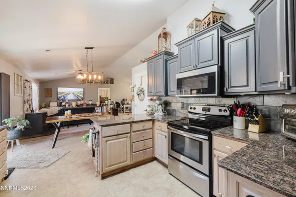 a kitchen with stainless steel appliances granite countertop a stove and cabinets