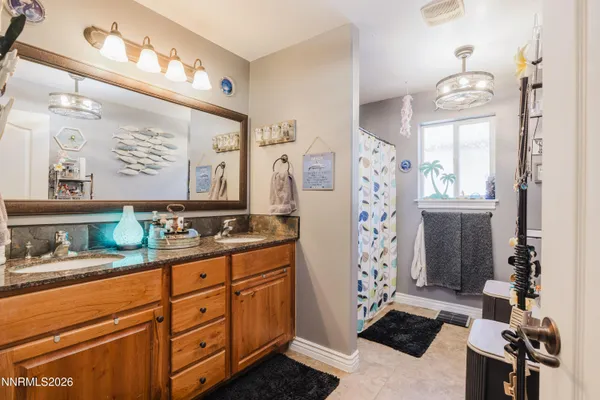 a spacious bathroom with double vanity and a mirror