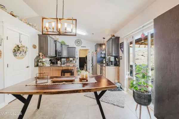 a view of a dining room with furniture a chandelier and wooden floor