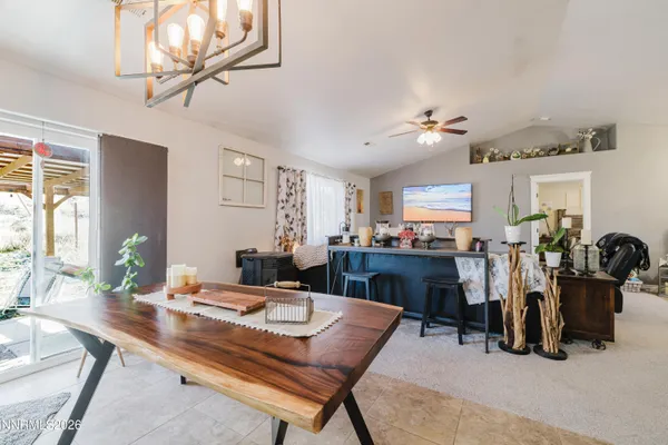 a room with a table chairs and a chandelier