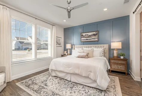 a bedroom with a large bed and a window