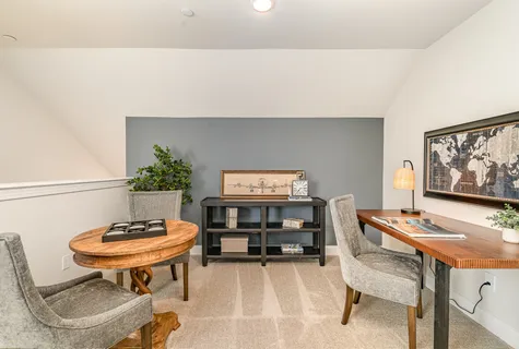 a living room with furniture and a ceiling fan