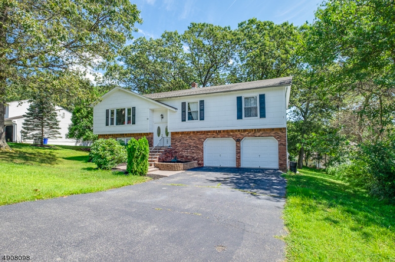 14 Ash Lane Randolph, NJ 07869 - Photo 19 of 22 a front view of a house with a garden and yard