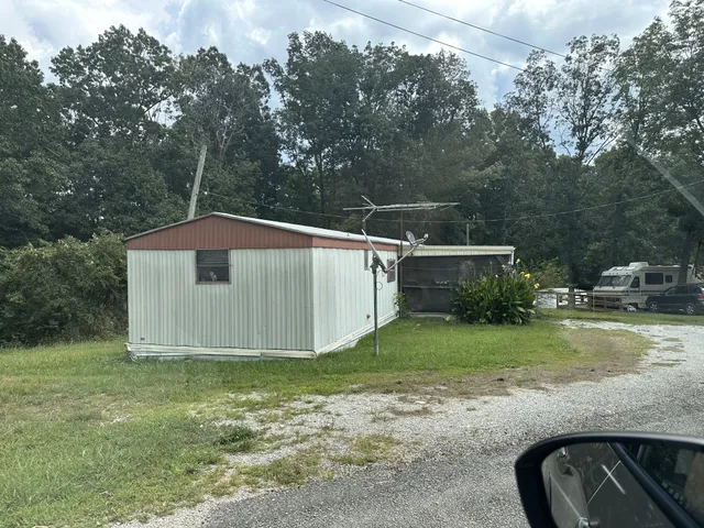 a view of a park with large trees