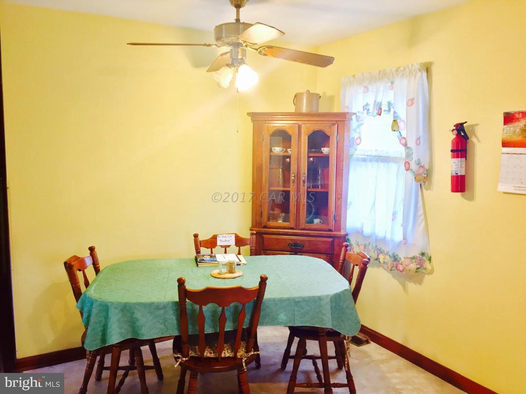 10817 Toddville Road Chance, MD 21821 - Photo 11 of 21 a view of a dining room with furniture and a table