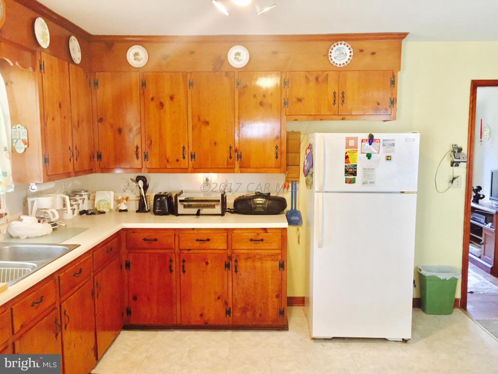 10817 Toddville Road Chance, MD 21821 - Photo 12 of 21 a kitchen with stainless steel appliances granite countertop a refrigerator and a stove