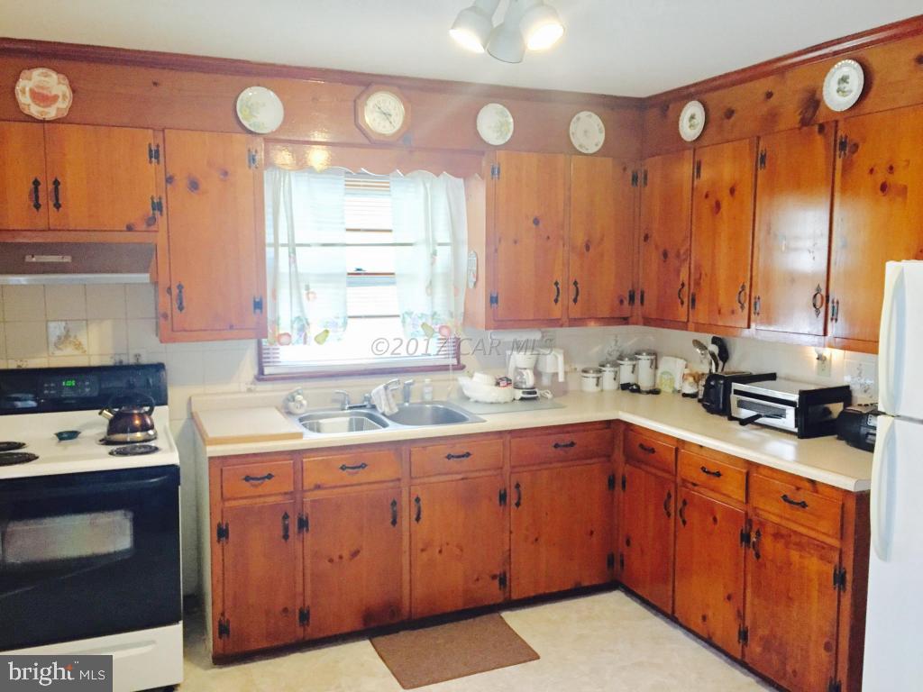 10817 Toddville Road Chance, MD 21821 - Photo 13 of 21 a kitchen with a sink stove and cabinets