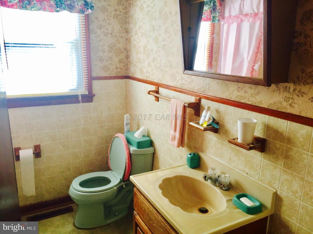 10817 Toddville Road Chance, MD 21821 - Photo 16 of 21 a bathroom with a sink and a mirror