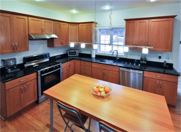 5 Squirrel Hill Road Acton, MA 01720 - Photo 11 of 30 a kitchen with stainless steel appliances wooden cabinets granite counter tops a stove a sink and a refrigerator