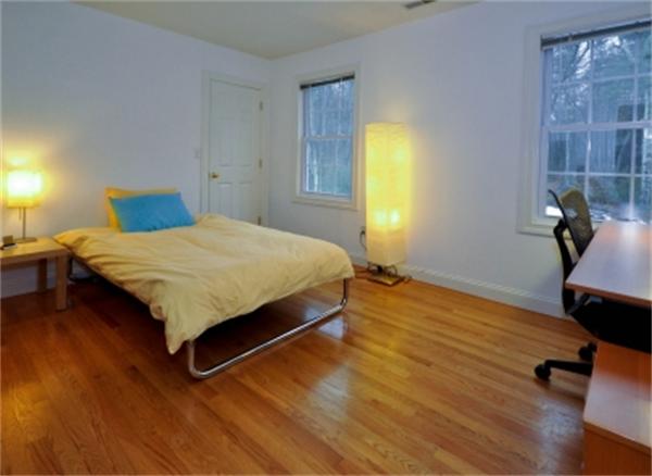 5 Squirrel Hill Road Acton, MA 01720 - Photo 27 of 30 a bedroom with a bed and wooden floor