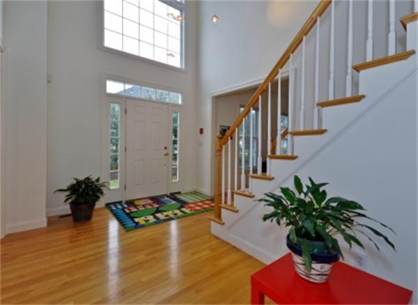 5 Squirrel Hill Road Acton, MA 01720 - Photo 4 of 30 a vase of flowers sitting on a wooden floor