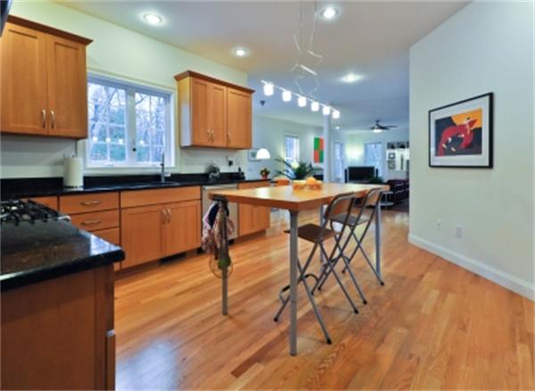 5 Squirrel Hill Road Acton, MA 01720 - Photo 10 of 30 a kitchen with stainless steel appliances granite countertop a table chairs sink and cabinets