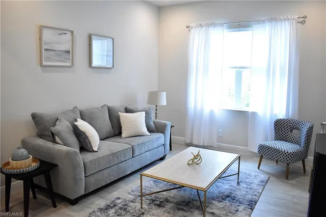 a living room with furniture and a window