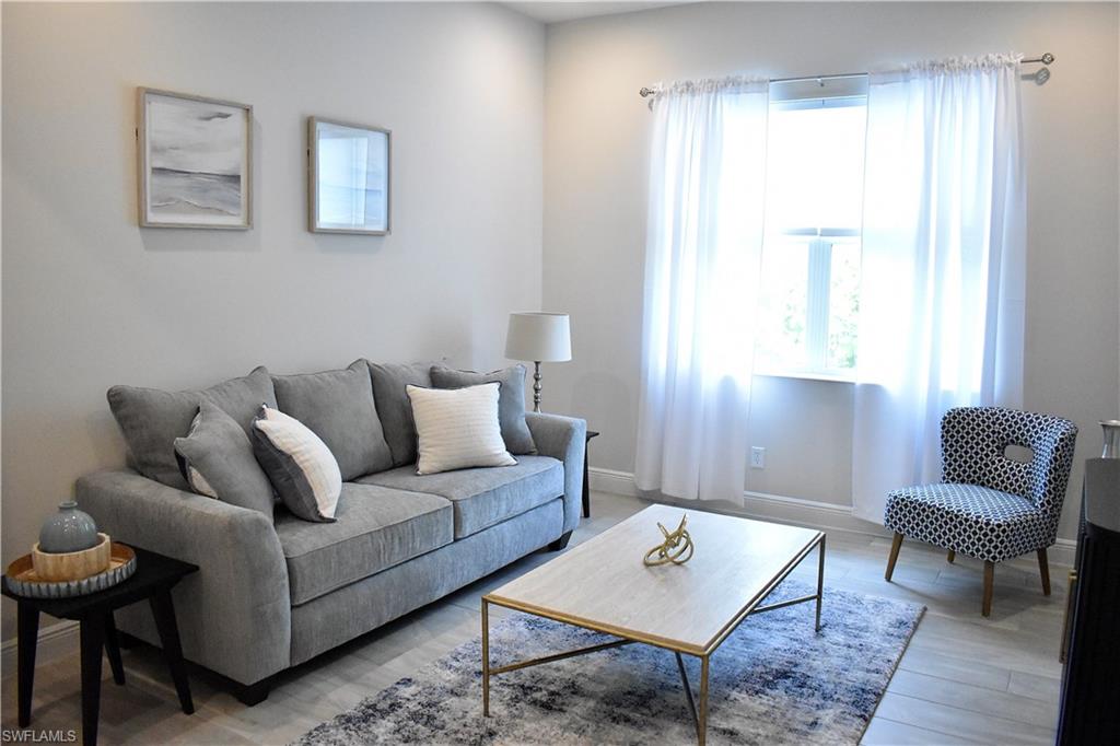 9175 Cayman Drive Naples, FL 34114 - Photo 16 of 31 a living room with furniture and a window