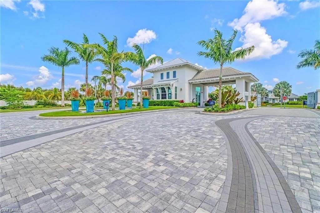 9175 Cayman Drive Naples, FL 34114 - Photo 17 of 31 a front view of a house with a yard and potted plants