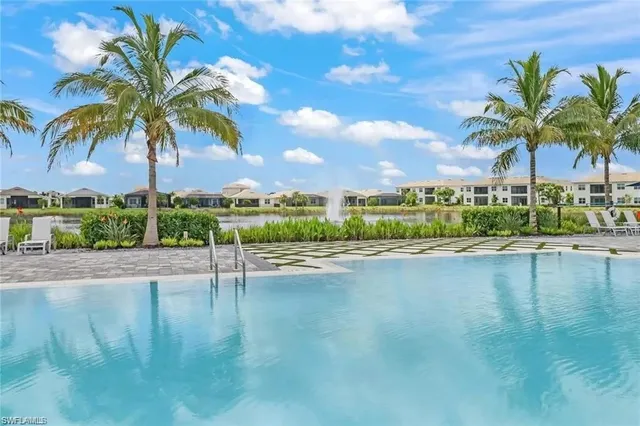 a view of swimming pool with a table and chairs
