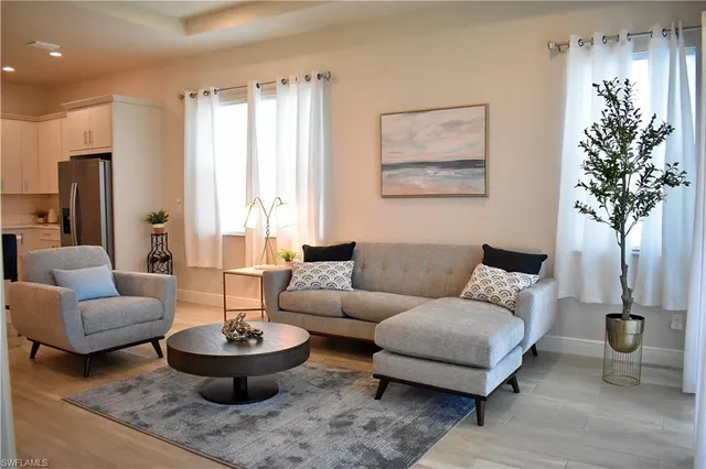 a living room with furniture and a potted plant
