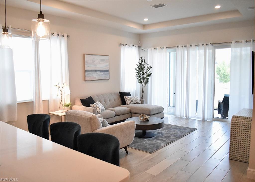 9175 Cayman Drive Naples, FL 34114 - Photo 3 of 31 a living room with furniture and a chandelier