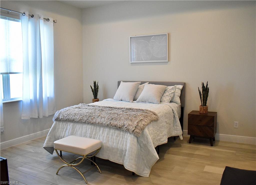 9175 Cayman Drive Naples, FL 34114 - Photo 6 of 31 a bedroom with a bed and a window