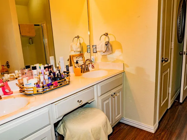 a bathroom with a sink mirror vanity and toilet