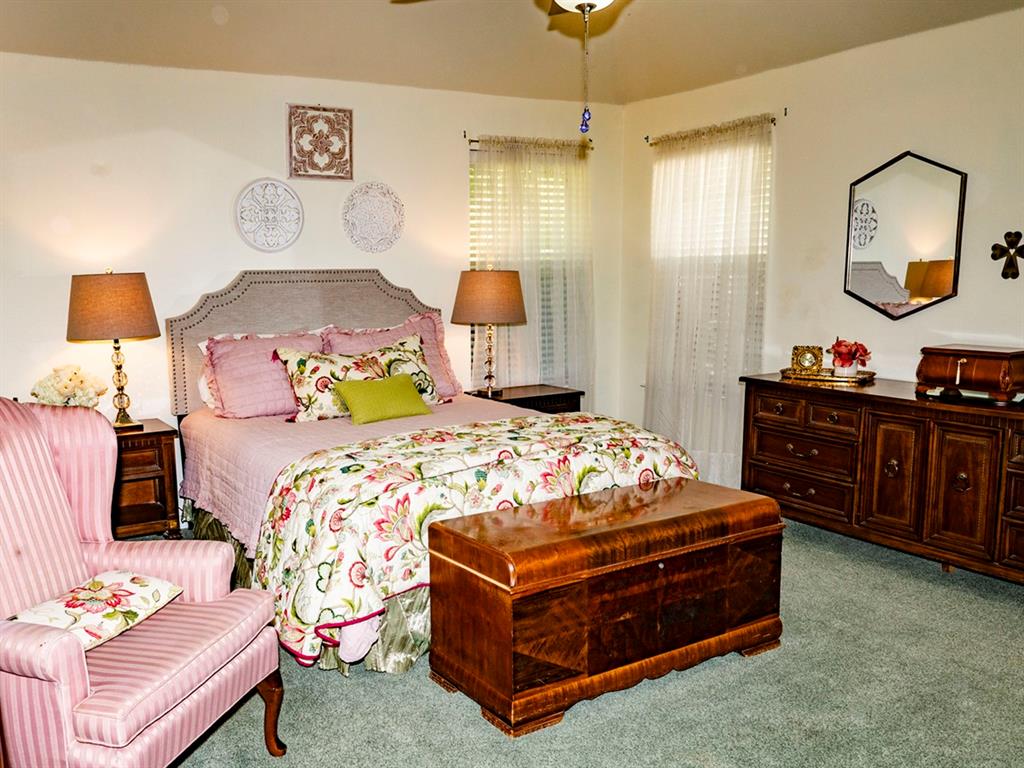 9028 Racquet Club Drive Fort Worth, TX 76120 - Photo 25 of 26 a bedroom with a bed and window