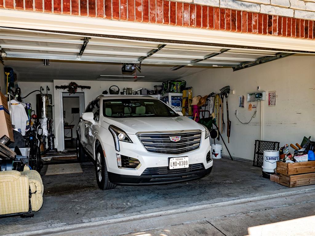9028 Racquet Club Drive Fort Worth, TX 76120 - Photo 26 of 26 a car parked in a garage