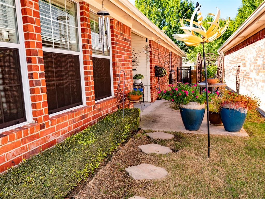9028 Racquet Club Drive Fort Worth, TX 76120 - Photo 4 of 26 a view of a chairs and table in a backyard