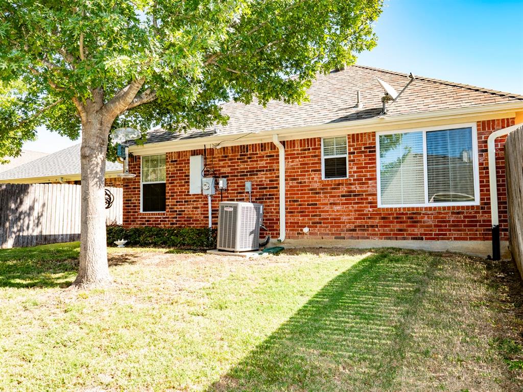 9028 Racquet Club Drive Fort Worth, TX 76120 - Photo 7 of 26 front view of a house with a yard