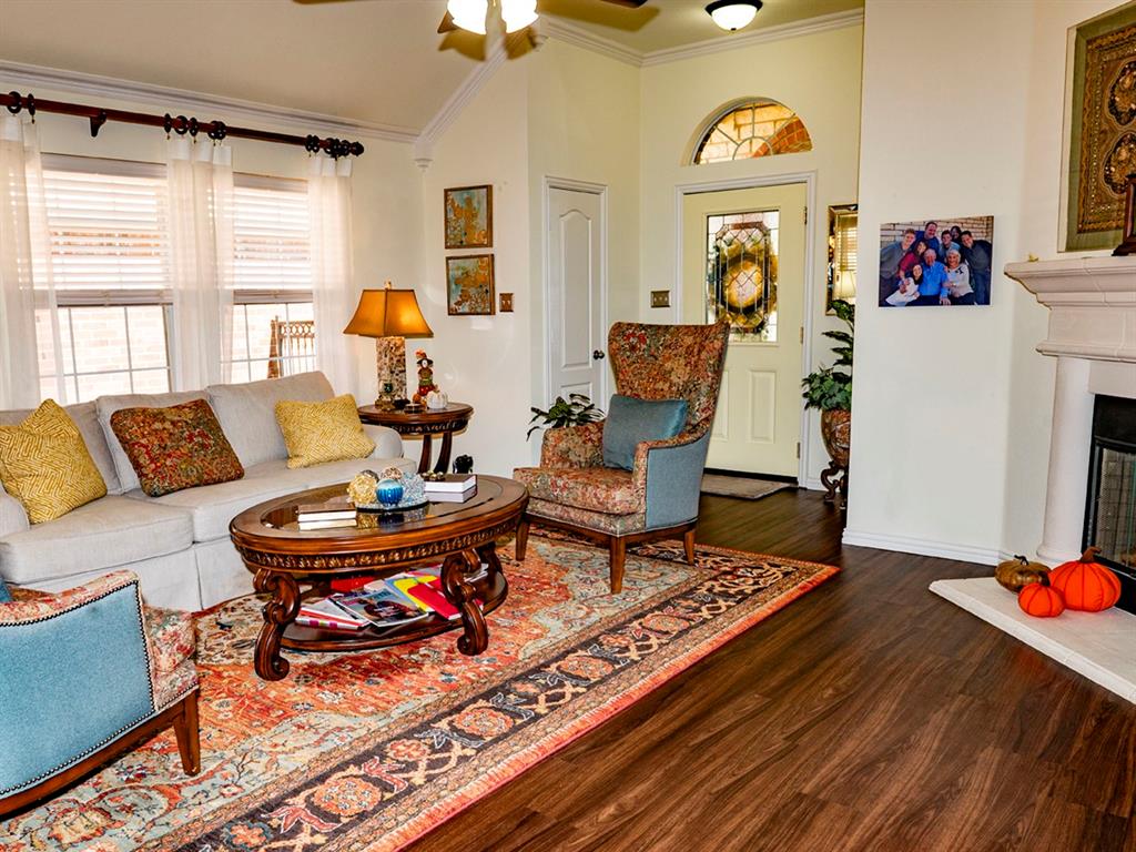 9028 Racquet Club Drive Fort Worth, TX 76120 - Photo 8 of 26 a living room with furniture and wooden floor
