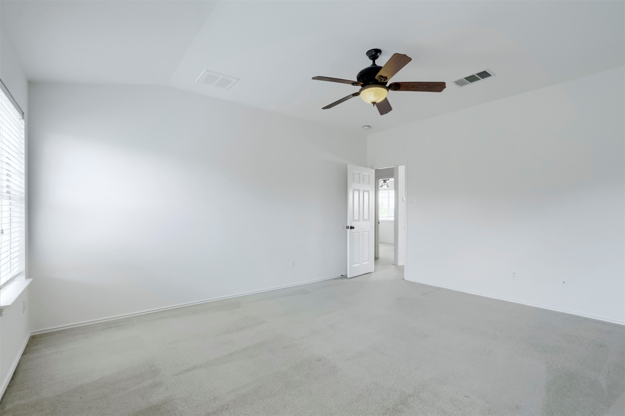 4125 Pebble Ridge Cove Round Rock, TX 78681 - Photo 18 of 30 A spacious, naturally illuminated room featuring a convenient ceiling fan and plush carpeting.