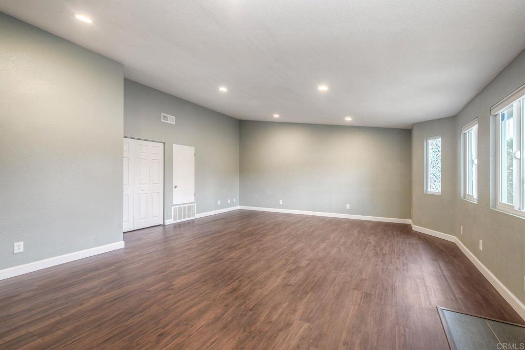 769 Magnolia Avenue, Unit B Carlsbad, CA 92008 - Photo 1 of 25 an empty room with wooden floor and windows