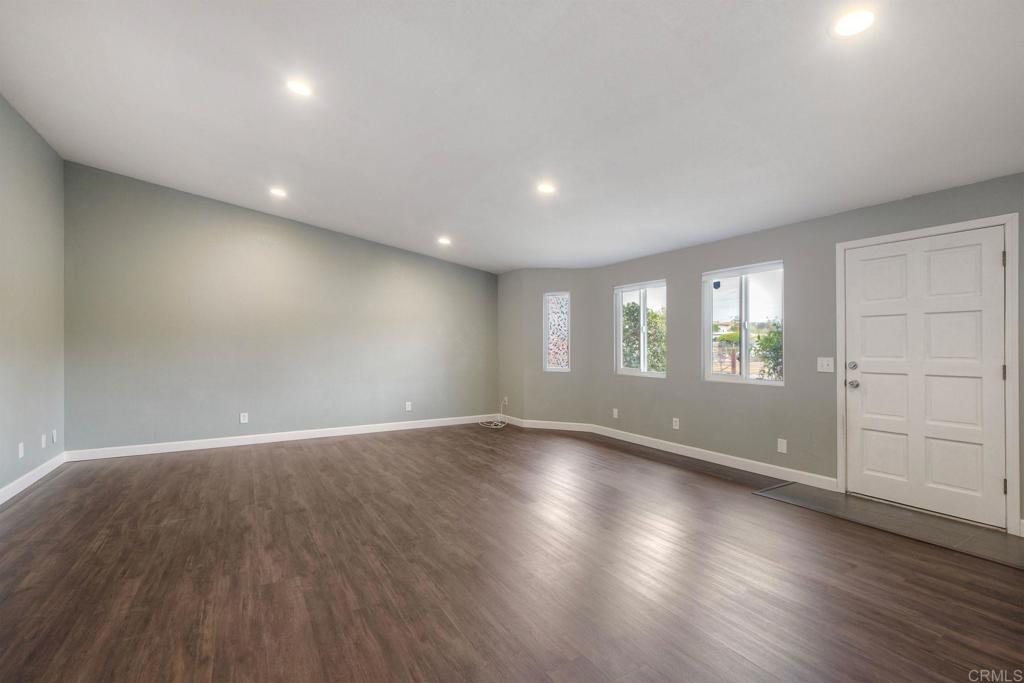 769 Magnolia Avenue, Unit B Carlsbad, CA 92008 - Photo 2 of 25 an empty room with wooden floor and windows