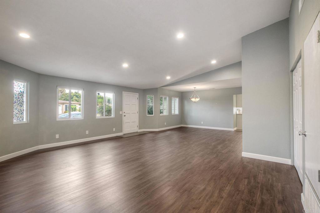 769 Magnolia Avenue, Unit B Carlsbad, CA 92008 - Photo 3 of 25 an empty room with wooden floor and windows