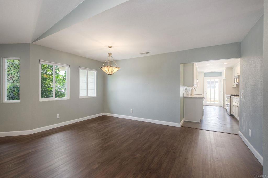 769 Magnolia Avenue, Unit B Carlsbad, CA 92008 - Photo 6 of 25 an empty room with wooden floor and windows