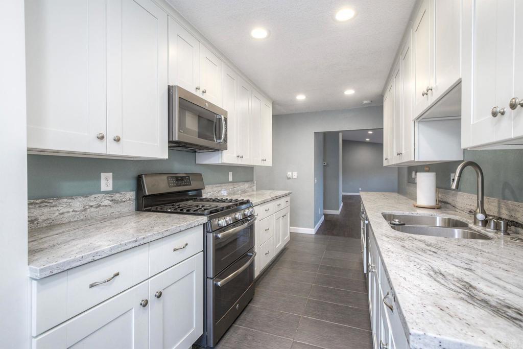 769 Magnolia Avenue, Unit B Carlsbad, CA 92008 - Photo 10 of 25 a large kitchen with stainless steel appliances granite countertop a stove a sink and a granite counter tops