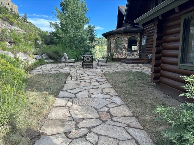 a view of a chairs and table in backyard