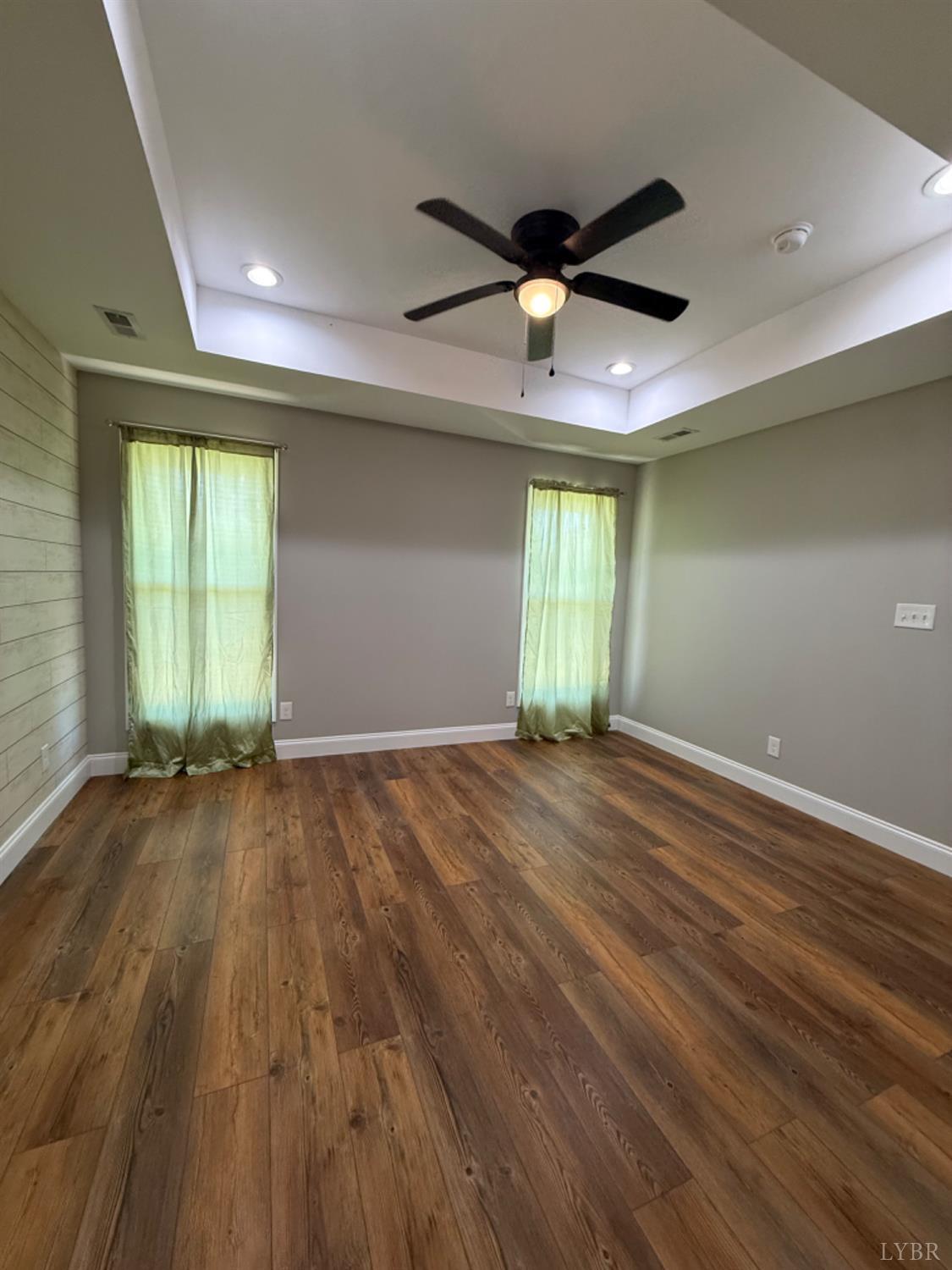 129 Ned Brown Road Amherst, VA 24521 - Photo 16 of 30 an empty room with wooden floor and windows