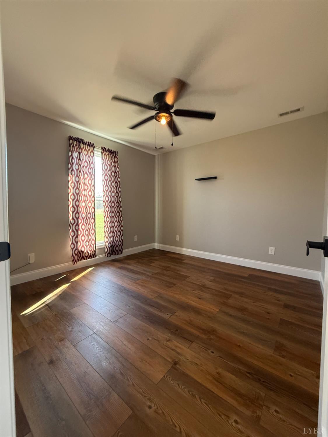 129 Ned Brown Road Amherst, VA 24521 - Photo 20 of 30 an empty room with wooden floor and windows