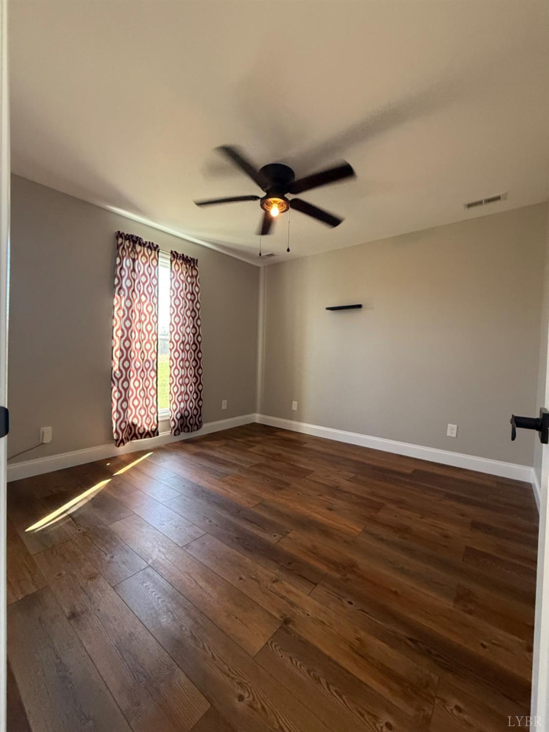 129 Ned Brown Road Amherst, VA 24521 - Photo 21 of 30 wooden floor in an empty room with a window