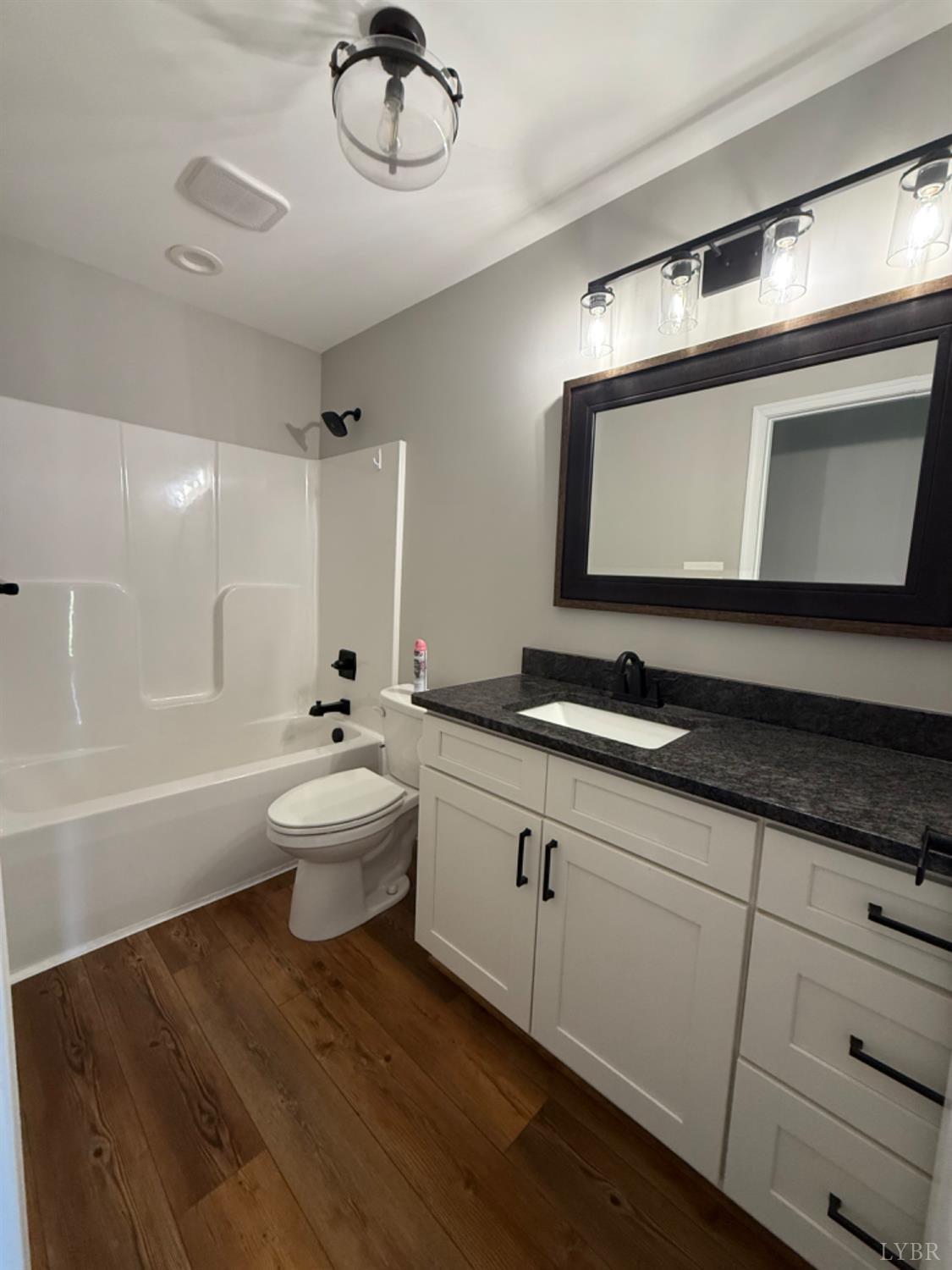 129 Ned Brown Road Amherst, VA 24521 - Photo 22 of 30 a bathroom with a double vanity sink a mirror and a bathtub