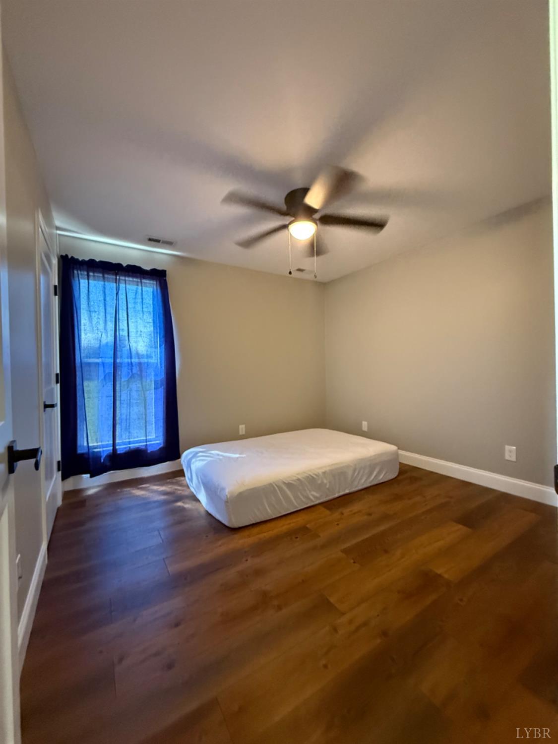 129 Ned Brown Road Amherst, VA 24521 - Photo 24 of 30 a big room with wooden floor and chandelier fan