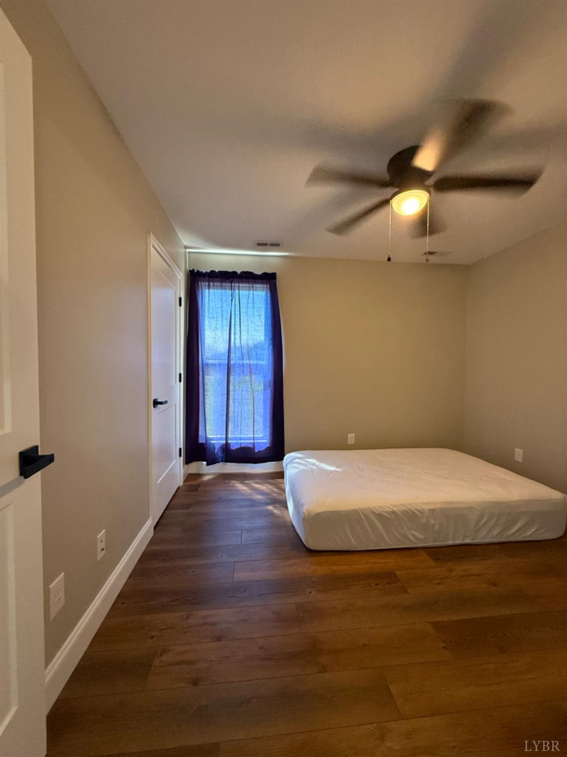 129 Ned Brown Road Amherst, VA 24521 - Photo 25 of 30 a bedroom with a bed and a chandelier
