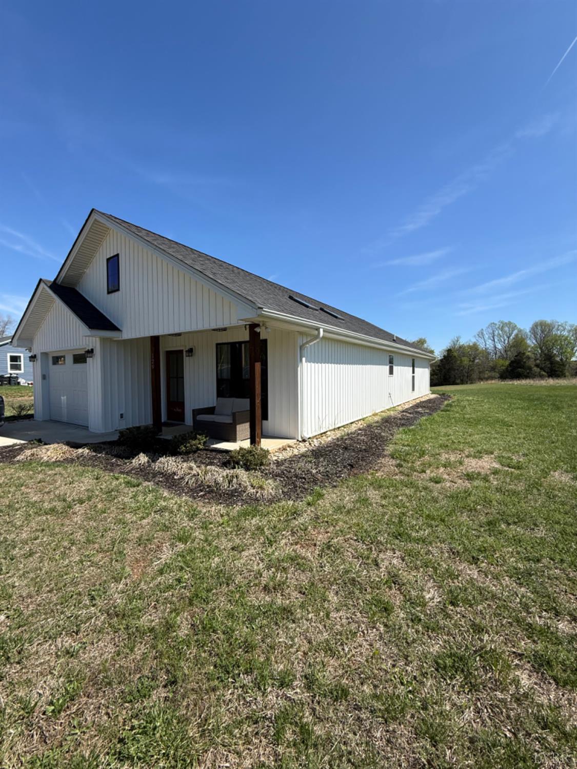 129 Ned Brown Road Amherst, VA 24521 - Photo 29 of 30 a front view of a house with a garden and yard