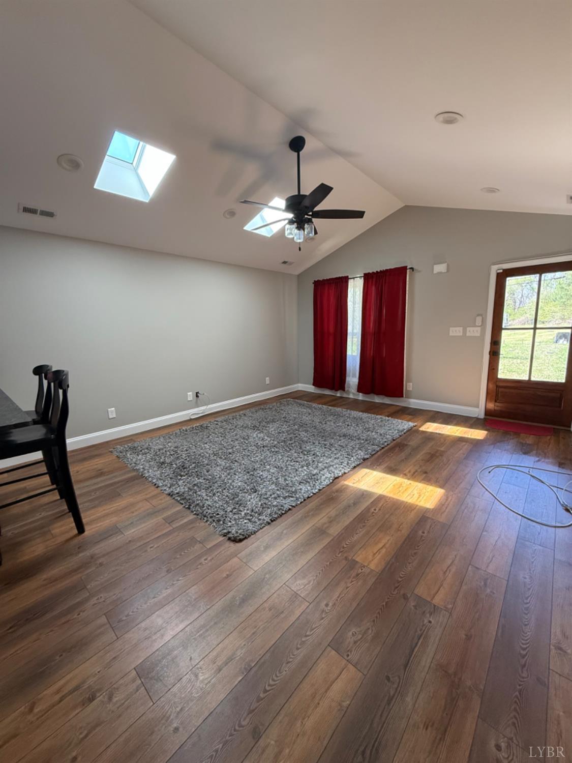 129 Ned Brown Road Amherst, VA 24521 - Photo 7 of 30 a view of an empty room with window and wooden floor