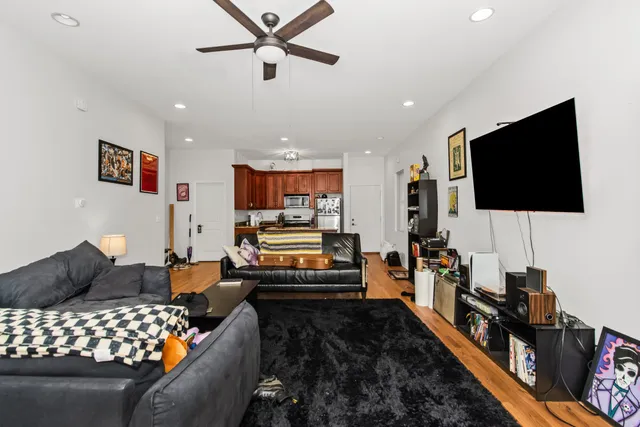 a kitchen with stainless steel appliances granite countertop a refrigerator a stove and a sink