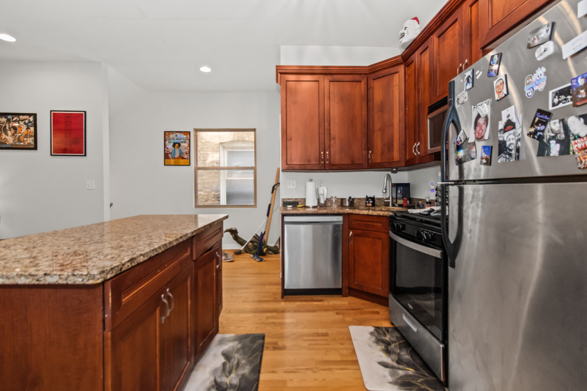 2710 North Artesian Avenue Chicago, IL 60647 - Photo 22 of 61 a kitchen with stainless steel appliances granite countertop a refrigerator a stove and a sink