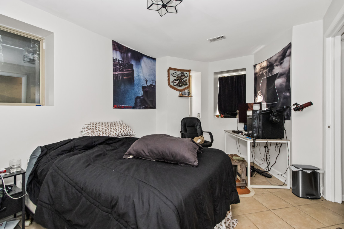 2710 North Artesian Avenue Chicago, IL 60647 - Photo 25 of 61 a bedroom with a bed and a flat tv screen