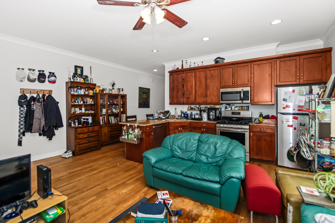 2710 North Artesian Avenue Chicago, IL 60647 - Photo 3 of 61 a living room with furniture kitchen view and a flat screen tv